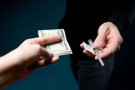 The dealer pushes the drug to the customer. Money exchange for drugsの写真素材