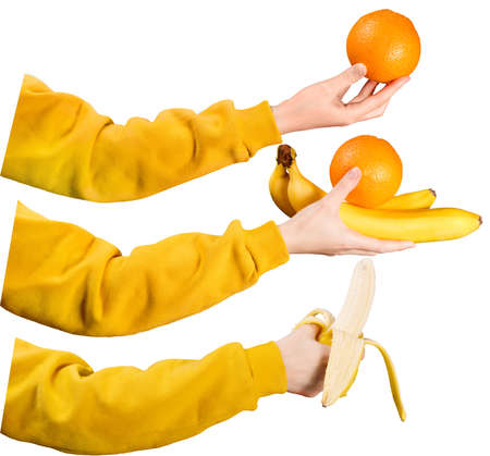 Set of female hands with fruits in their hands. Bananas and oranges in the hands of a girl. Isolatedの写真素材