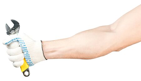 A male hand in a working glove holds an adjustable wrench. worker s hand Isolatedの写真素材