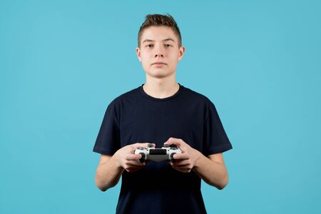cute teenager with a modified joystick in hands on a blue background