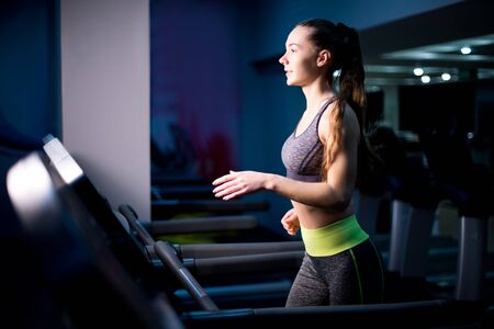 side view portrait of a girl on a treadmill