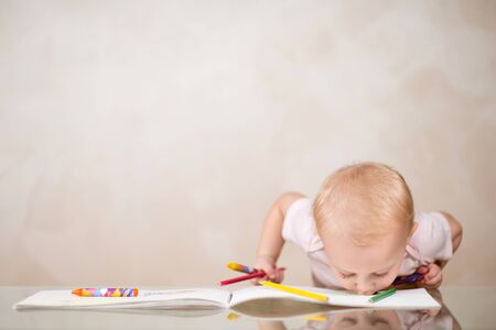 a little girl kisses a drawing in an album, so she likes him, copy space