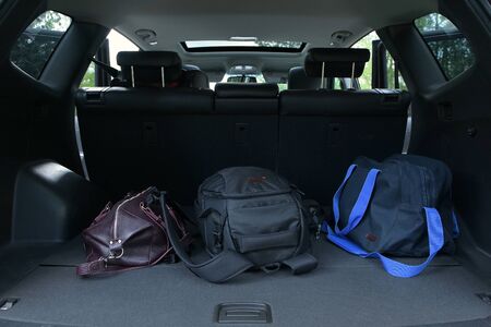 Three bags are in the trunk of an SUV. Travel Fees, close upの写真素材