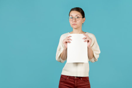 girl holds documents with blank page in her hands. office employeeの写真素材