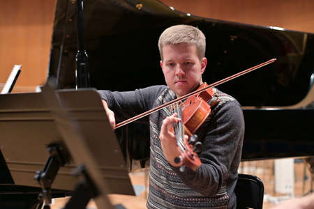 violinist playing the violin in the orchestra, rehearsal before the performance
