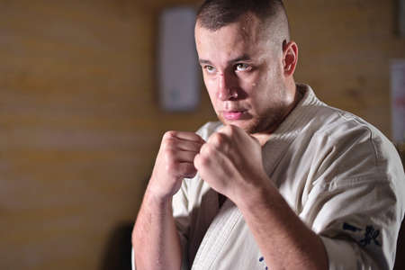 The karate fighter stands in a fighting stanceの写真素材