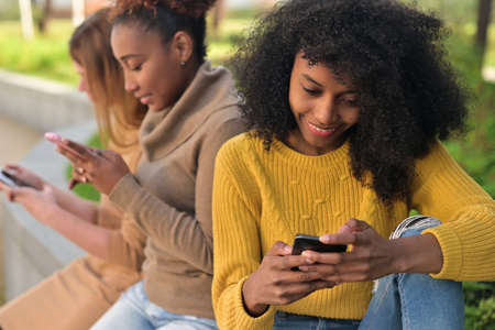 woman is leafing through a social network or looking at photos on her phoneの写真素材