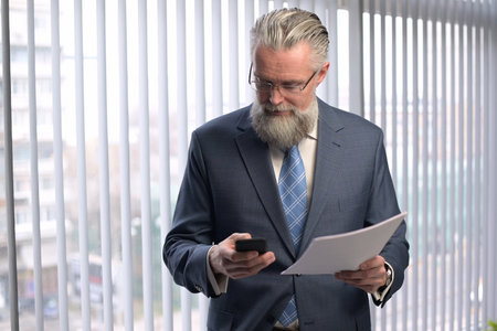 The mature gray-haired company executive examines the reports