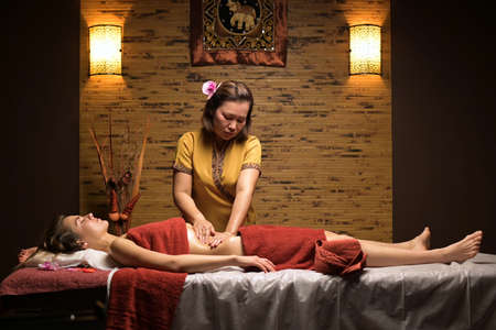 Thai massage session. Thai woman massage young beautiful womanの写真素材