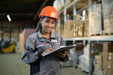 Portrait of a young black woman at work. Worker of productionの写真素材