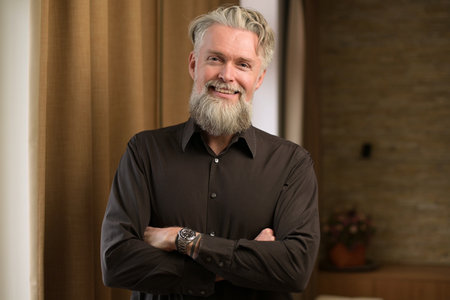 gray-haired bearded adult male smiling and showing positive dispositionの写真素材