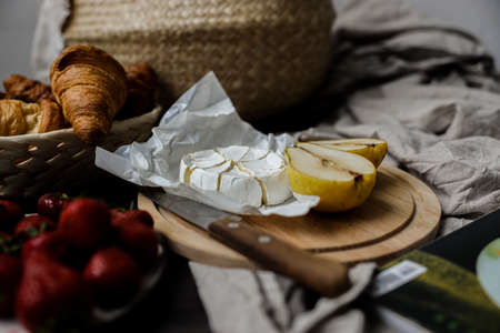 Cheese, Strawberry and sliced pieces of pears on a plate. Round piece of cheese for dessert. Fruit...