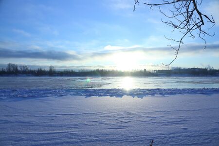 Beautiful winter day. Snow on the bank of the river. Trees under the snow. The low winter sun.の写真素材