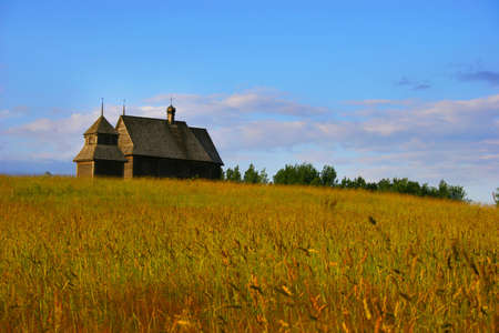 The old thrown house on a gold hill on a background of the dark blue skyの写真素材