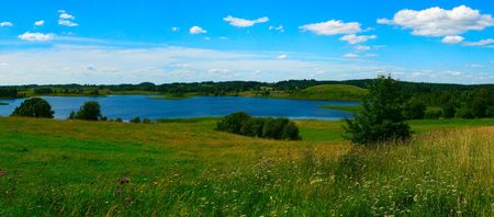 Beautiful panoramic landscape with the dark blue, cloudy, solar skyの写真素材