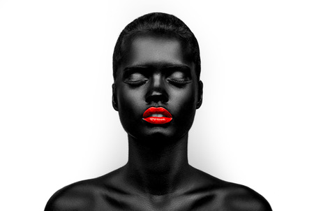 Female model with black skin and glossy red lips. Beauty make-up.の写真素材