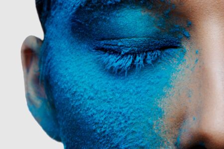 Half beauty face with blue makeupの写真素材