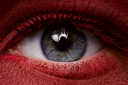 Closeup beauty eye with dark red paint on skinの写真素材