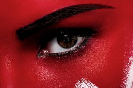 Bloody makeup. Closeup beauty face with blood on white skinの写真素材