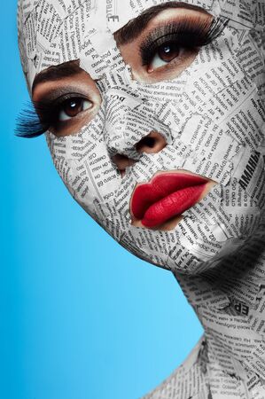 Beauty asian Girl with pink Lips and Newspaper on Faceの写真素材