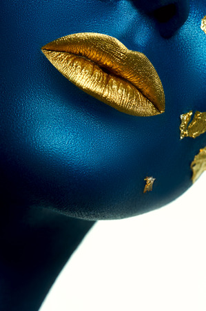 Fiction Beauty. Closeup gold Lips on blue Skin.の写真素材