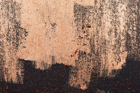 Brush Strokes of golden Paint on dark Surface