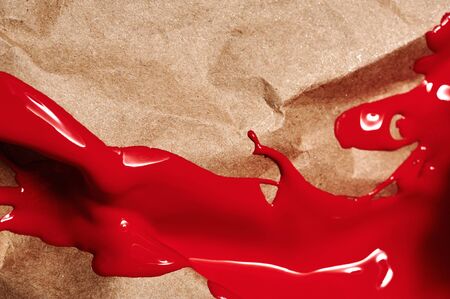 Red liquid Paint on brown craft wrinkled Paintの写真素材