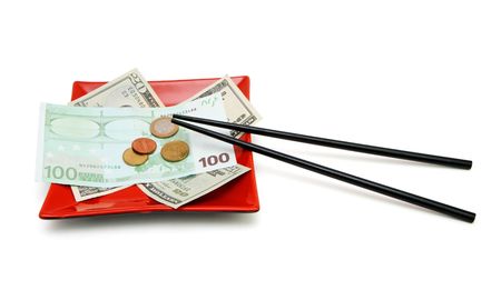 Money bills and coins on red square plate with chopsticks isolatedの写真素材