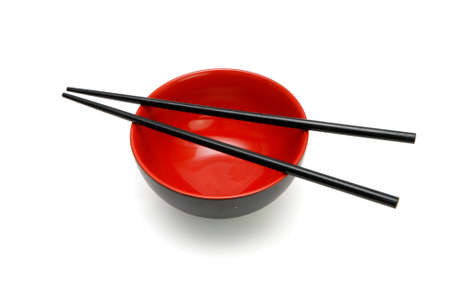 Chopsticks on  red and black bowl isolatedの写真素材