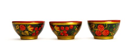 Three painted Russian khokhloma wooden cups isolatedの写真素材