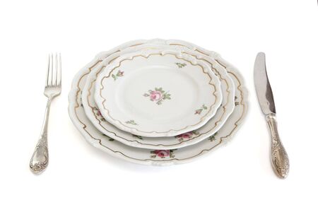 Dinner set with three plates, knife and fork isolatedの写真素材