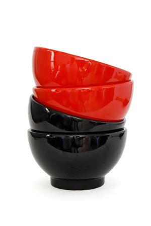 Zigzag stack of two red and two black porcelain bowls isolatedの写真素材