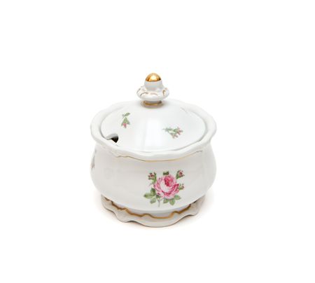 White porcelain sugar basin with roses isolated on white の写真素材