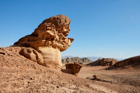 Scenic orange rock in shape of mushroom in stone desert, Israel