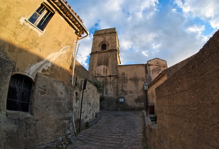 Fisheye view of medieval street in village of Savoca in Sicily, Italy, at sunsetの写真素材