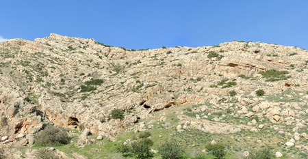 Texture of a layered sedimentary rock under the blue skyの写真素材
