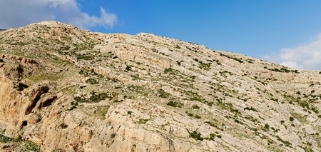 Texture of a layered sedimentary rock under the blue sky