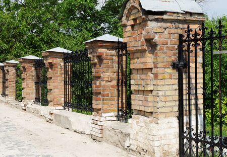 Brick and metal fence in Kiev Pechersk Lavra Monastery in Kiev, Ukraineの写真素材