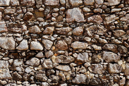Ancient rough stone wall textureの写真素材
