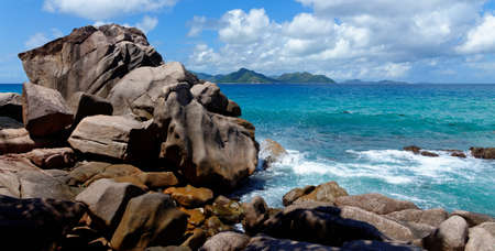Scenic granite rocks and ocean at Anse Severe  beach on La Digue island, Seychellesの写真素材