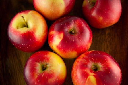 Red sweet apples on a wooden table