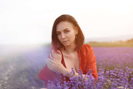 Beautiful dark haired young girl in the lavender field.の写真素材