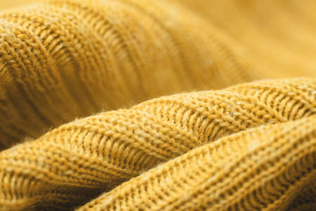 Close up of beautiful yellow knitted textured background. Trendy color.の写真素材