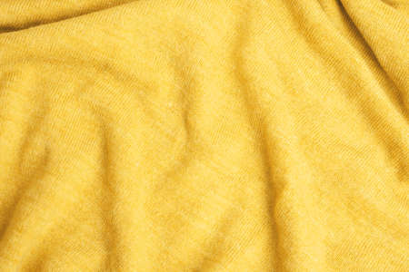 Close up of yellow knitted textured background. Trendy color.の写真素材