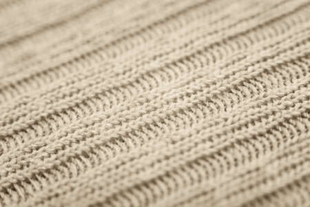 Close up of beige knitted textured background. Trendy color.の写真素材