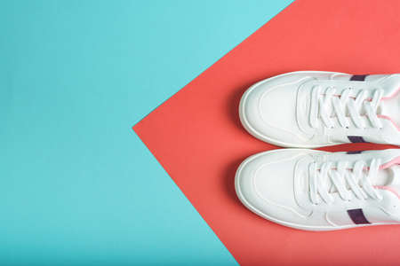 Flat lay of sport sneakers shoes on the blue and red colored background. Fitness background. Healthy lifestyle concept.の写真素材