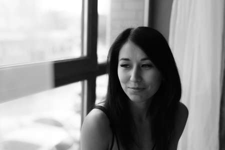 Portrait of beautiiful young woman on the black background.の写真素材