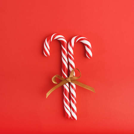 Christmas striped red and white hard candies connected with the ribbon.の写真素材