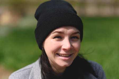 Beautiful girl sitting in the park and enjoying sunlight.