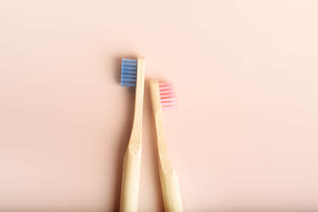 Two eco friendly natural bamboo toothbrushes on pink background.の写真素材